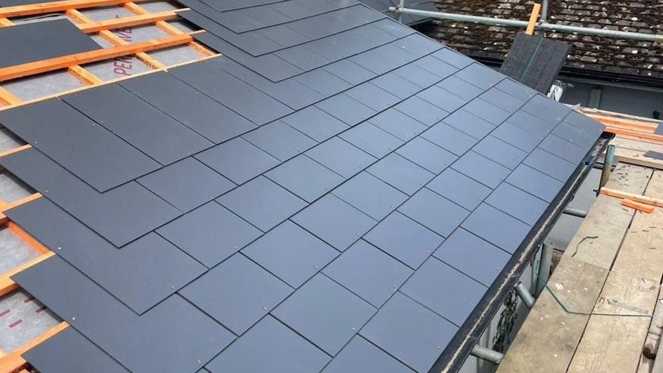 Slates going on over new battens and membrane on a StoneRidge Roofing re-roof in Ashford