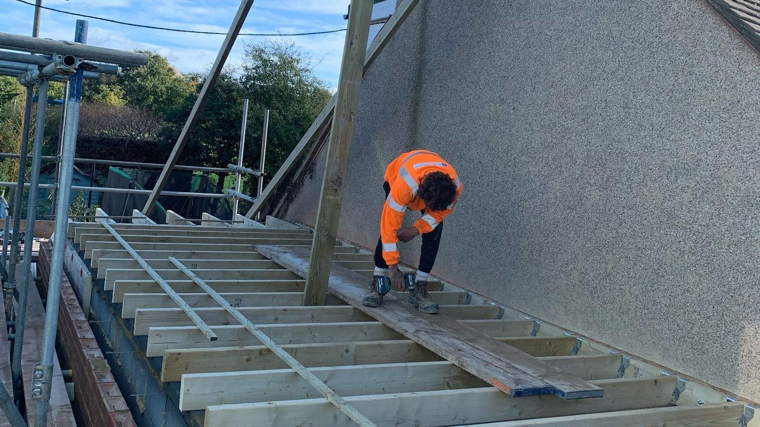 One of the StoneRidge Roofing team fixing the roof joists on an extension in Folkestone