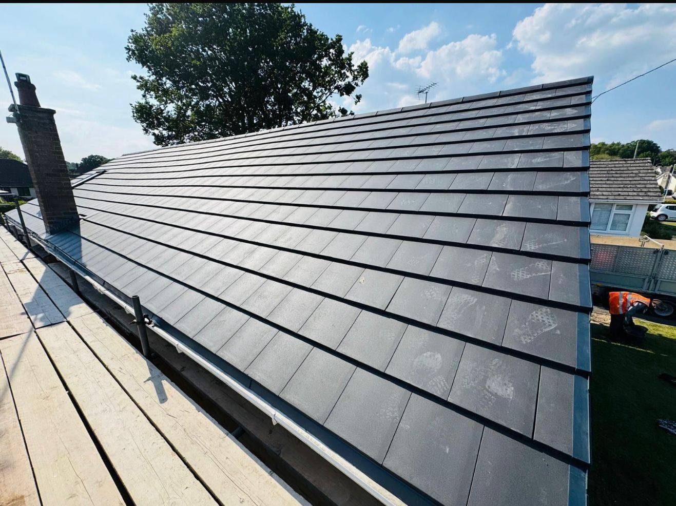 New slate roof being finished from the scaffold by StoneRidge Roofing