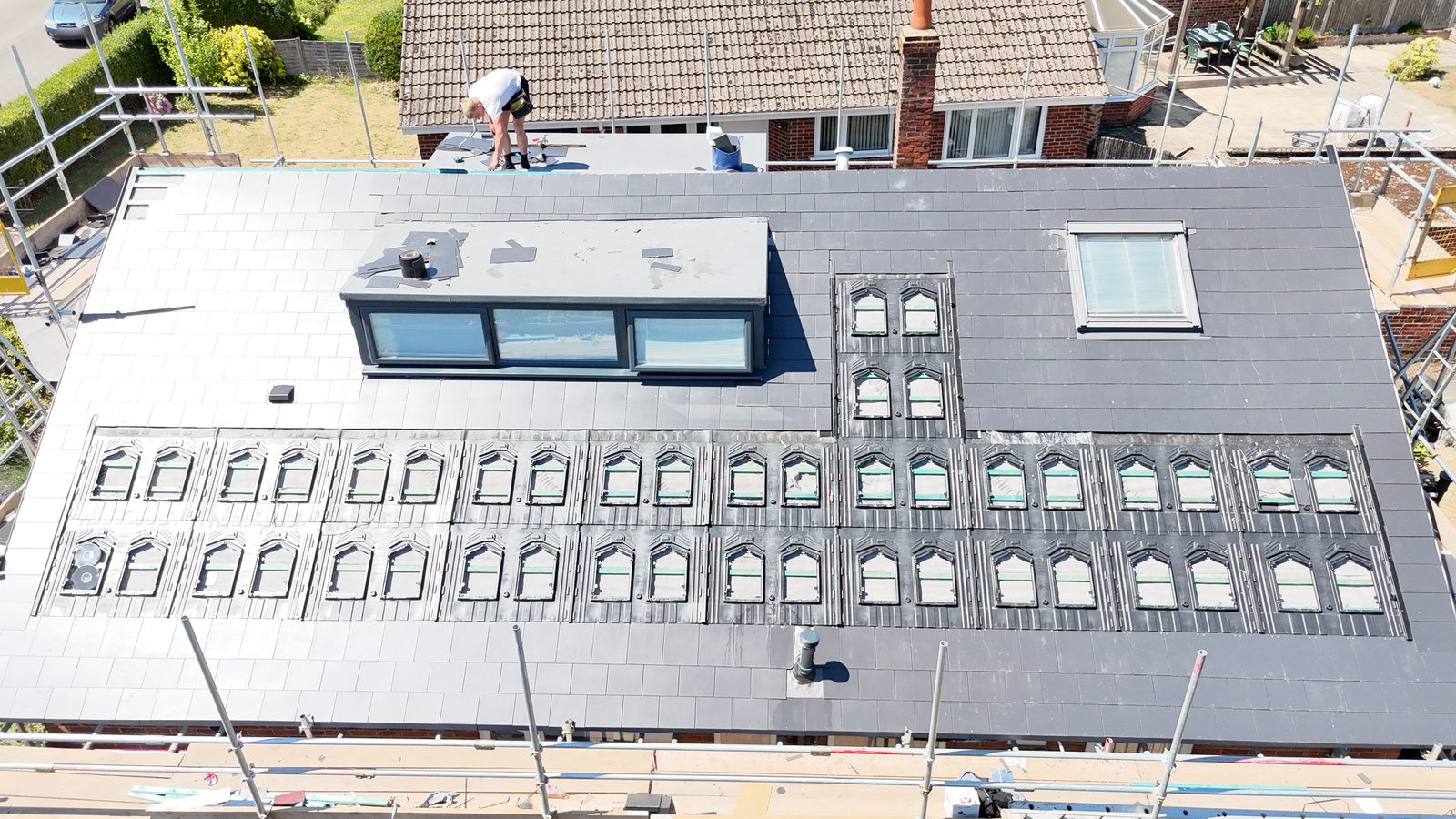 A StoneRidge Roofing re-roof in progress, with the in-roof solar trays and new dormer in place